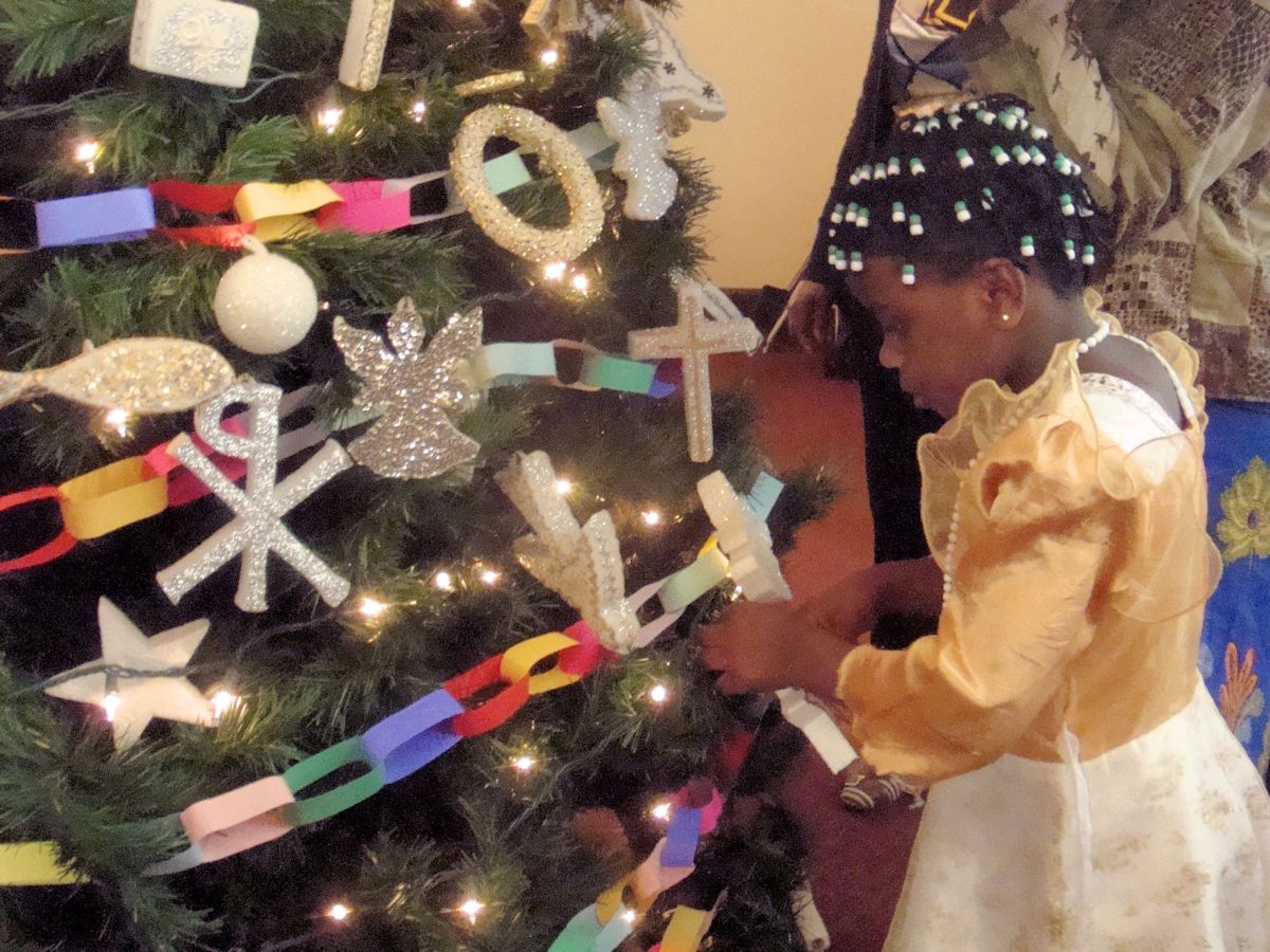 Rachel adds an ornament on her first Christmas tree in the U.S.