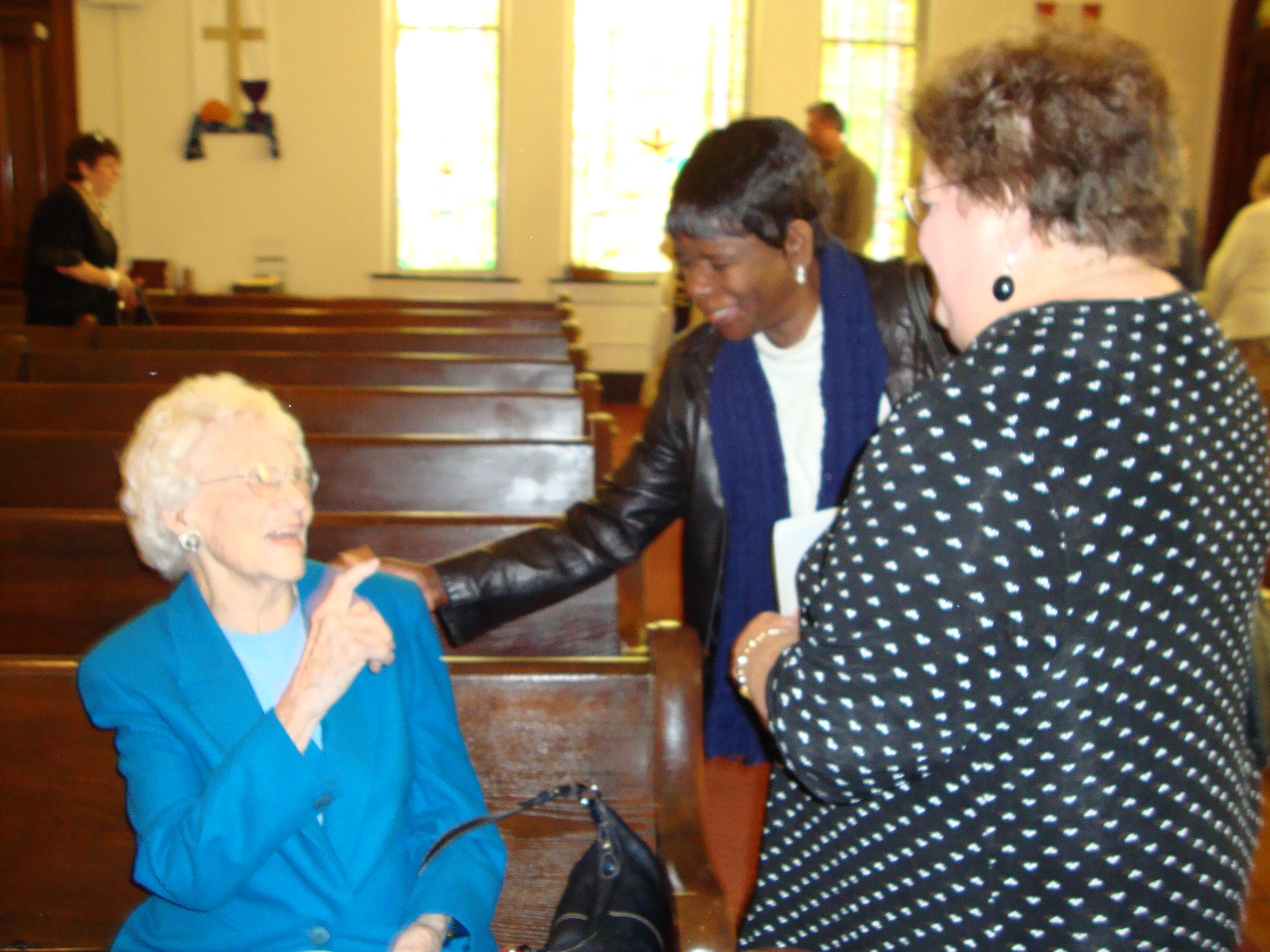 Constance K. sharing the Peace with a young visitor on September 5, 2010