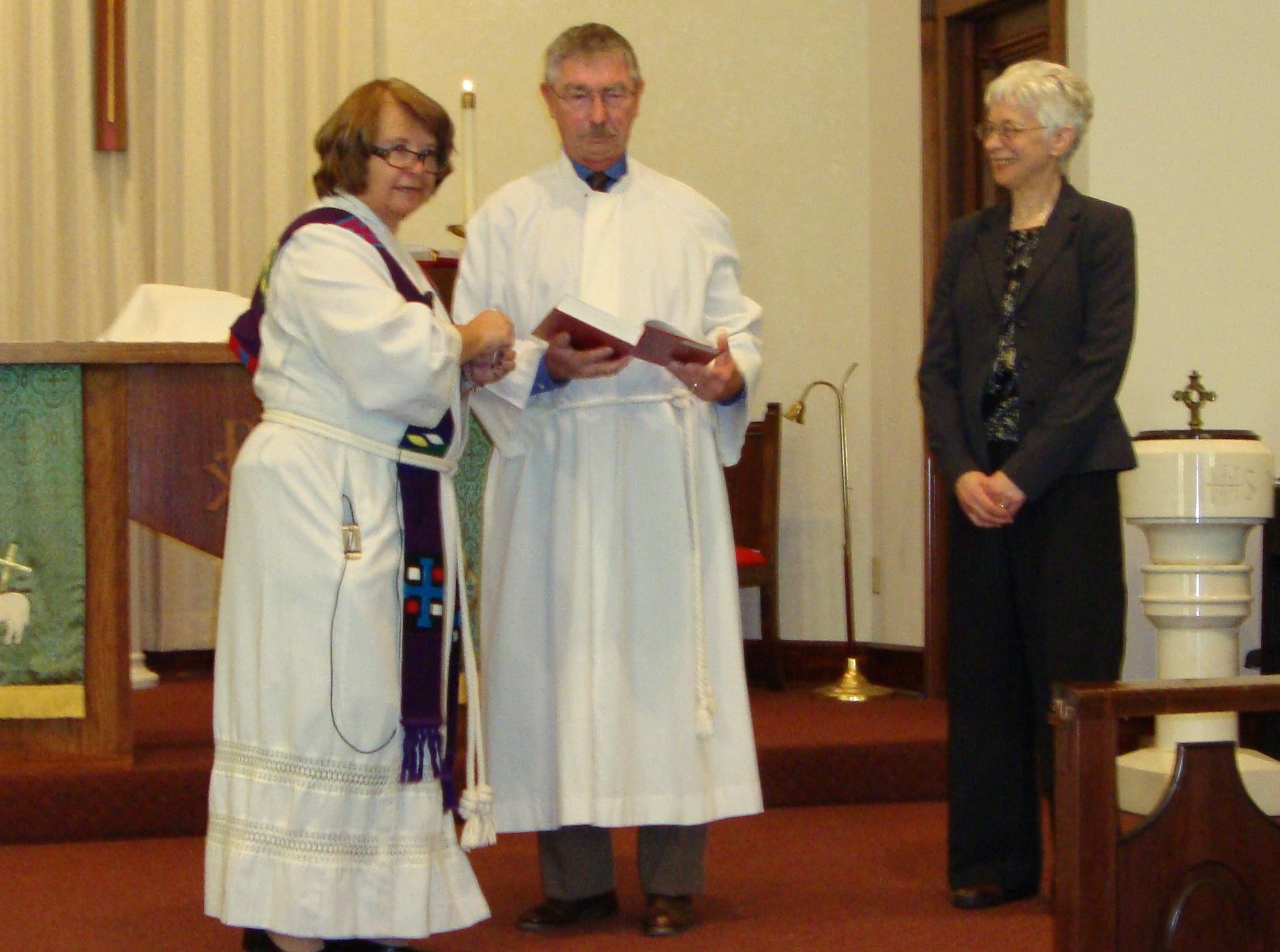 Pastor Bonnie Sparks, Ralph Oberlander lead the blessing of Rhunell Gruender's music ministry.