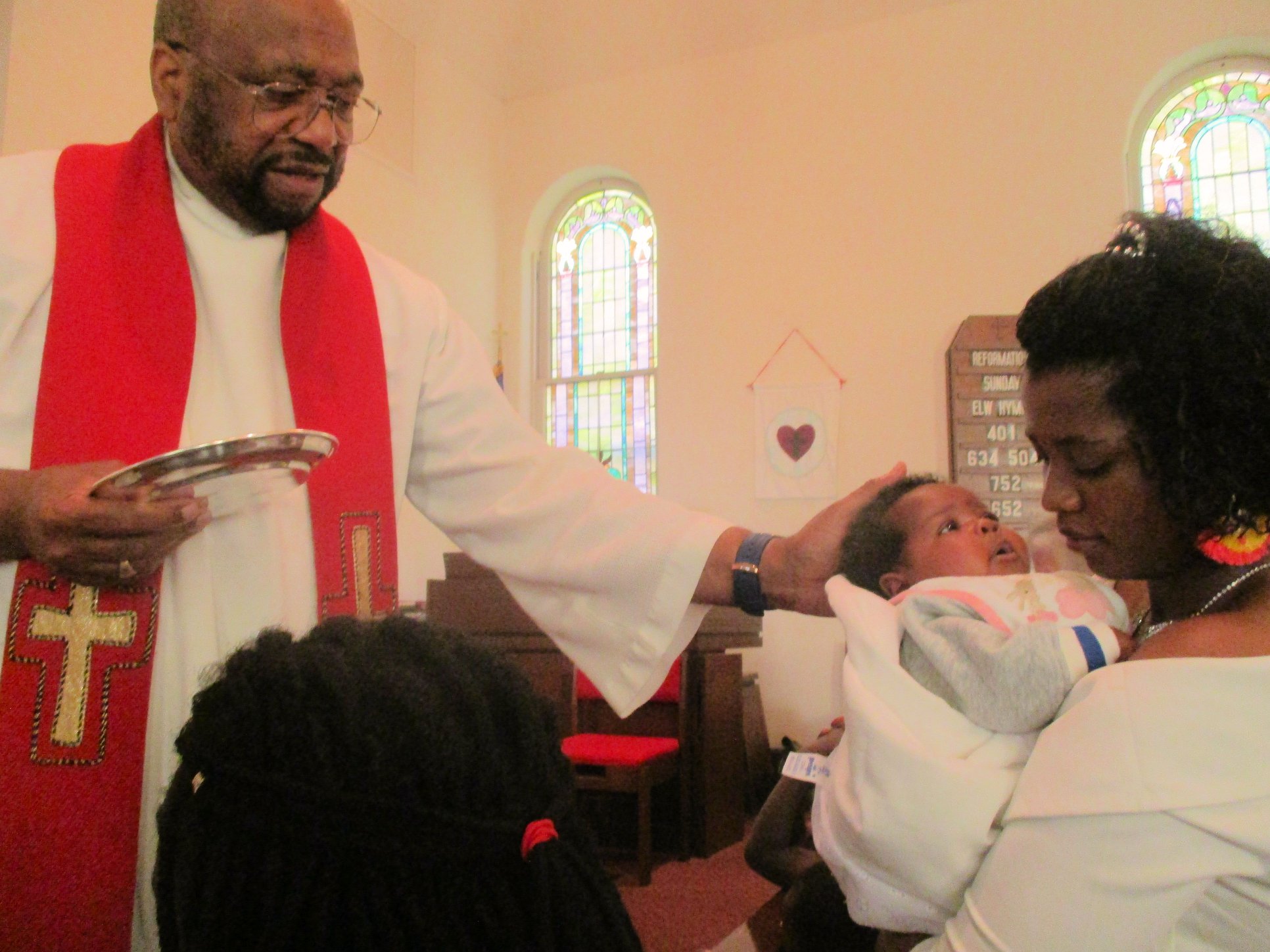 Pastor Capers blesses 6-week-old Aaliyah on Reformation Sunday 2019.